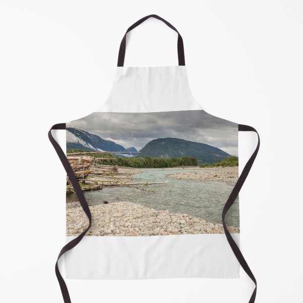 Item preview, Log jam at the Shames and Skeena River confluence, on a cloudy day, with forest and mountains in the background. designed and sold by SnapTPhotograph.