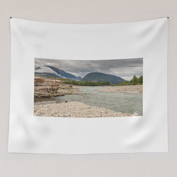 Item preview, Log jam at the Shames and Skeena River confluence, on a cloudy day, with forest and mountains in the background. designed and sold by SnapTPhotograph.