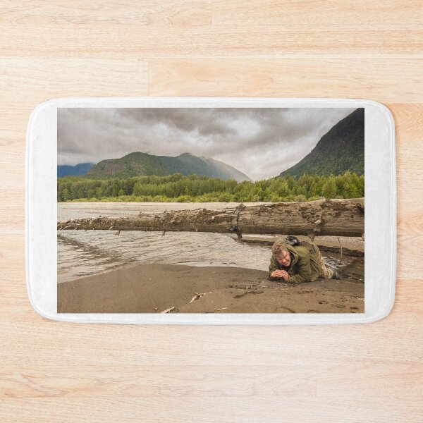 Item preview, A man crawling under a large fallen tree in British Columbia, Canada designed and sold by SnapTPhotograph.