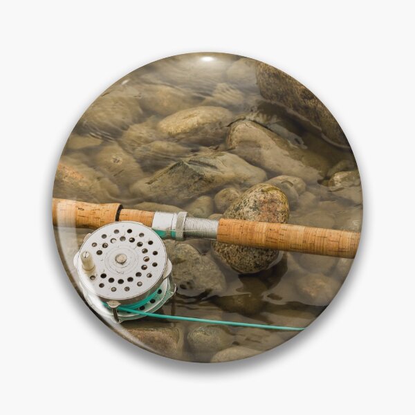 Item preview, Spey fly rod and reel resting on wet rocks beside a river. designed and sold by SnapTPhotograph.