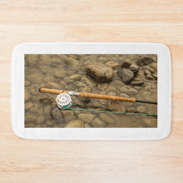 Item preview, Spey fly rod and reel resting on wet rocks beside a river. designed and sold by SnapTPhotograph.