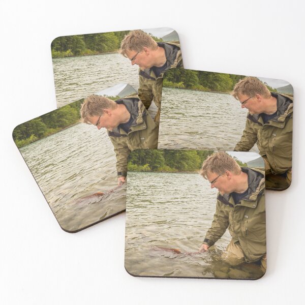 Item preview, A fisherman watches a sockeye salmon swim away, after being released back into the river designed and sold by SnapTPhotograph.