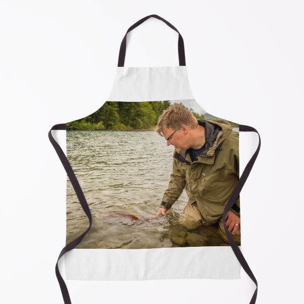 Item preview, A fisherman watches a sockeye salmon swim away, after being released back into the river designed and sold by SnapTPhotograph.
