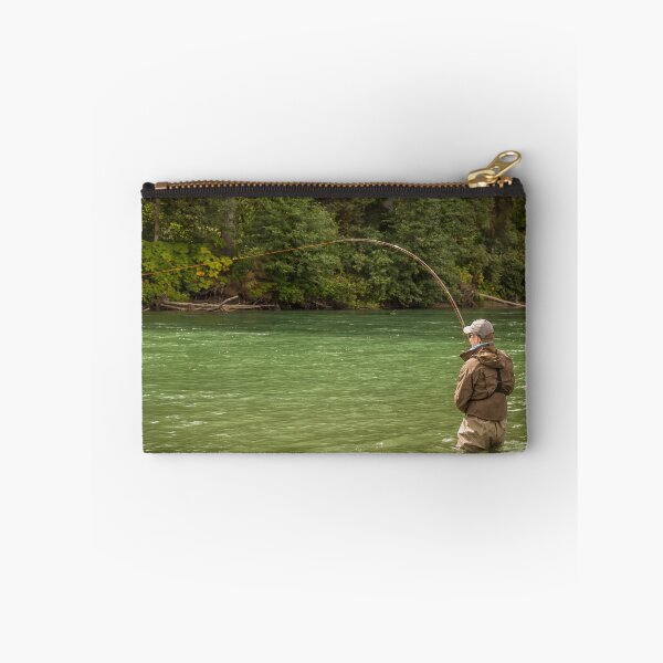 Item preview, A man hooked into a fish while fly fishing on a deep green river designed and sold by SnapTPhotograph.