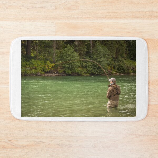 Item preview, A man hooked into a fish while fly fishing on a deep green river designed and sold by SnapTPhotograph.