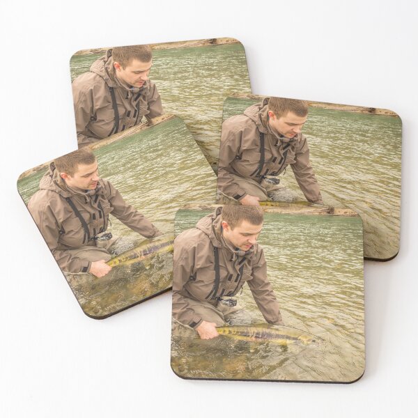 Item preview, A fisherman releasing a chum salmon back into the river, while wading designed and sold by SnapTPhotograph.