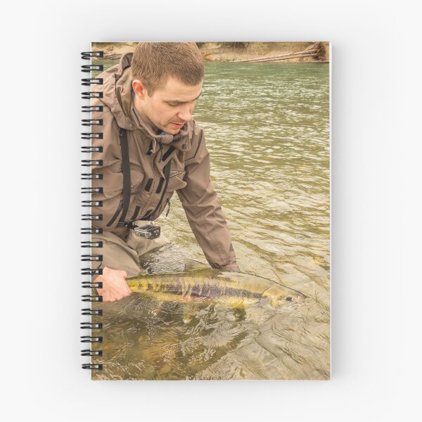 Item preview, A fisherman releasing a chum salmon back into the river, while wading designed and sold by SnapTPhotograph.