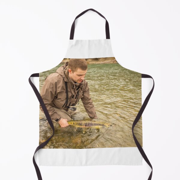 Item preview, A fisherman releasing a chum salmon back into the river, while wading designed and sold by SnapTPhotograph.