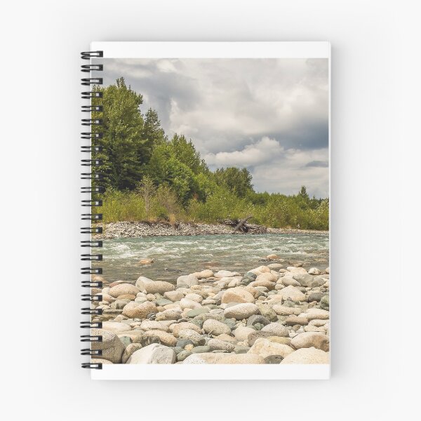 Item preview, A boulder strewn, fast flowing river, beside a forest, on a cloudy day. designed and sold by SnapTPhotograph.