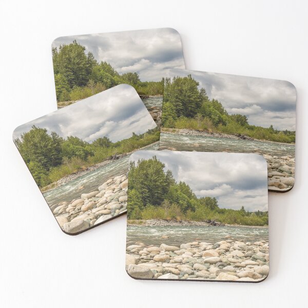 Item preview, A boulder strewn, fast flowing river, beside a forest, on a cloudy day. designed and sold by SnapTPhotograph.