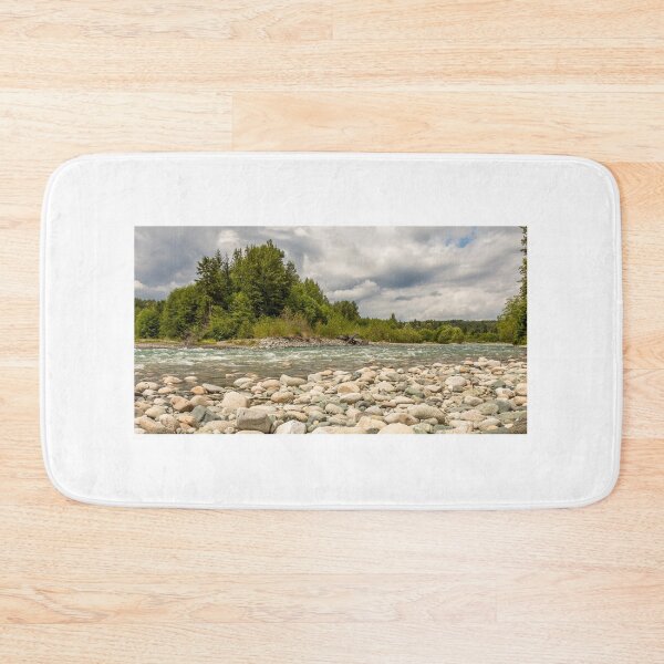 Item preview, A boulder strewn, fast flowing river, beside a forest, on a cloudy day. designed and sold by SnapTPhotograph.