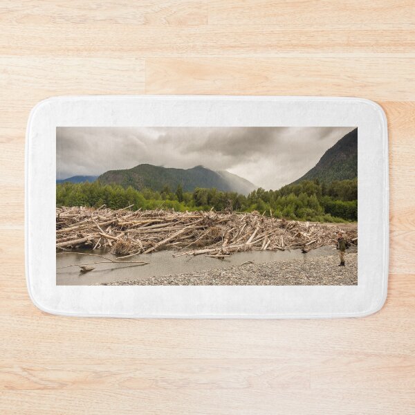 Item preview, A man standing beside a very big log jam on a river in British Columbia, Canada designed and sold by SnapTPhotograph.