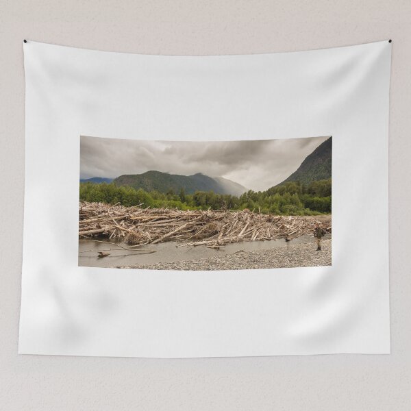 Item preview, A man standing beside a very big log jam on a river in British Columbia, Canada designed and sold by SnapTPhotograph.