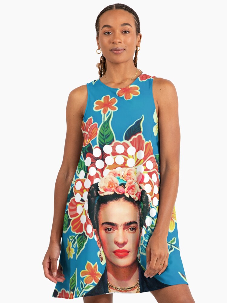Frida Kahlo print, flowers, color on blue Mexican tablecloth