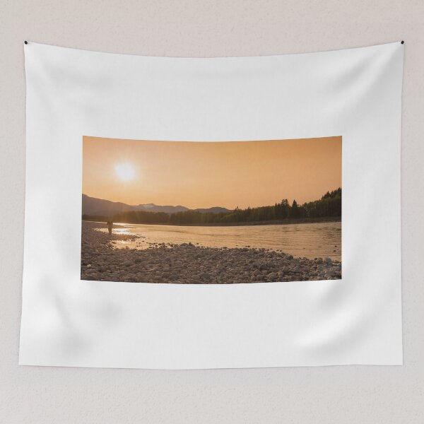 Item preview, A fisherman walking along a gravel bar beside the Skeena River at sunset designed and sold by SnapTPhotograph.