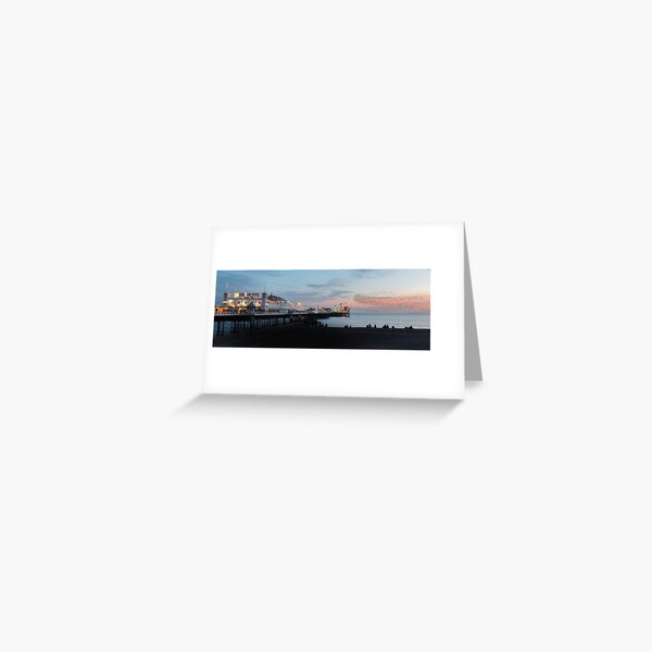 Brighton Pier at Sunset with a murmuration of Starlings flying above. Greeting Card