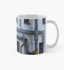 ventilation pipes on the wall of a building Mug