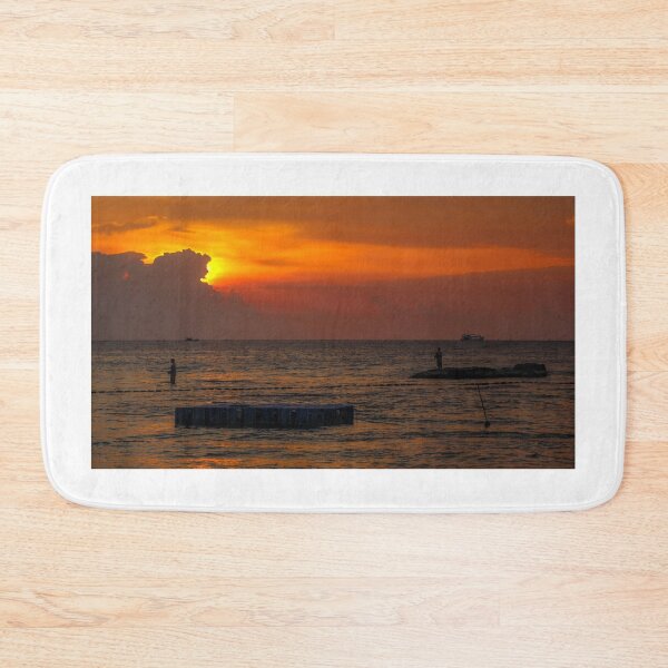 Item preview, A silhouette of fishermen standing on rocks at sunset at Ba Keo Beach designed and sold by SnapTPhotograph.