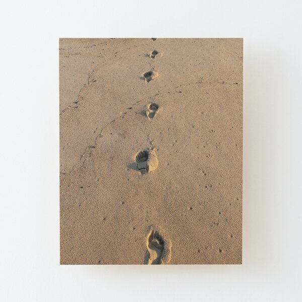 Bare footprints on the coastal sand Wood Mounted Print