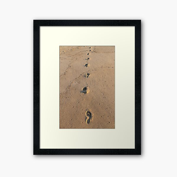 Bare footprints on the coastal sand Framed Art Print