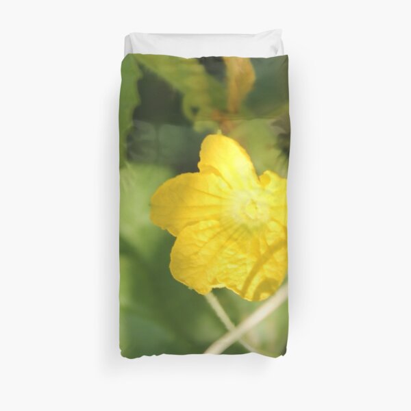 Yellow unnamed flower on a background of green leaves Duvet Cover