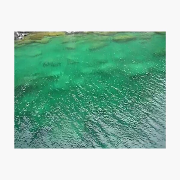 Stones Across The Water-Emerald Green water with stones and waves Photographic Print