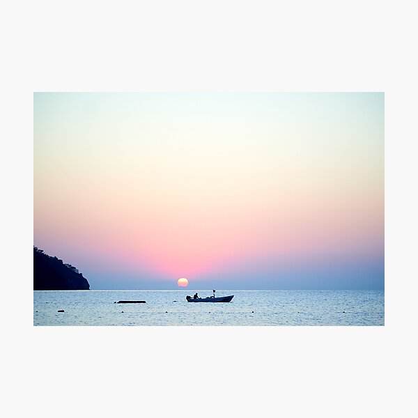 Item preview, Orange sunset above sea with boat amazing Golden reflection of the sun on the calm waves designed and sold by RaimondKlavins.