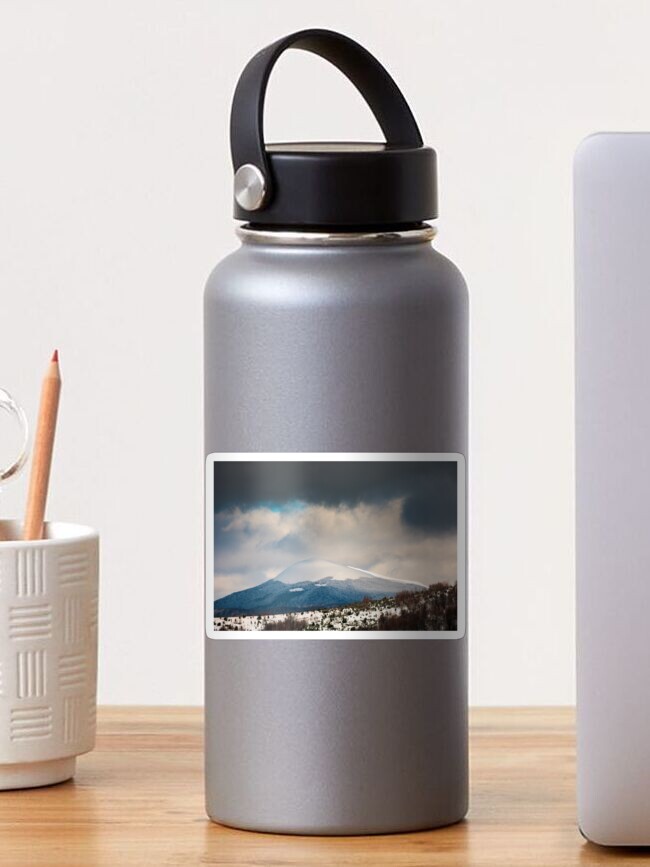 Thumbnail 1 of 3, Sticker, dramatic sky above the distant snowy peak designed and sold by mike-pellinni.