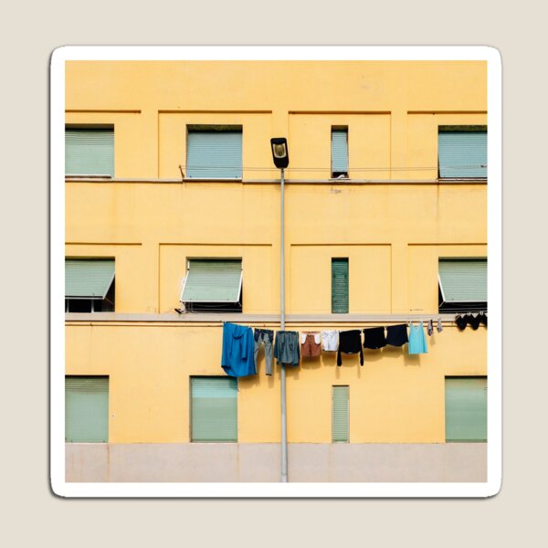 Item preview, Laundry Drying on Washing Line Against Yellow Building Facade in Italy designed and sold by visualspectrum.