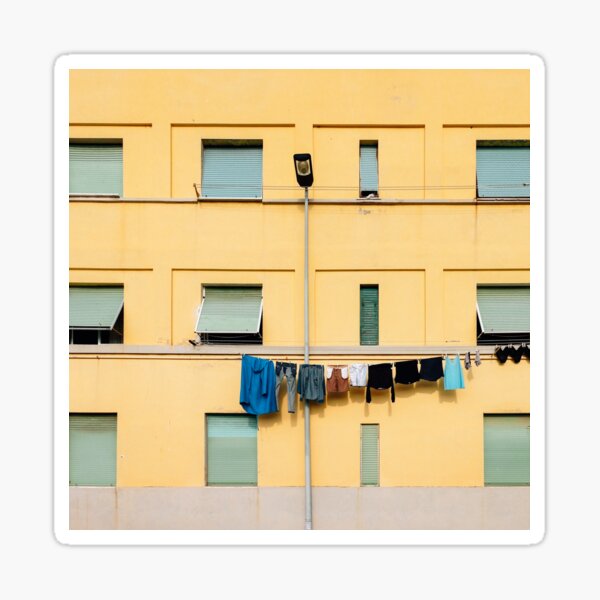 Item preview, Secado de ropa en línea de lavado contra fachada de edificio amarillo en Italia designed and sold by visualspectrum.