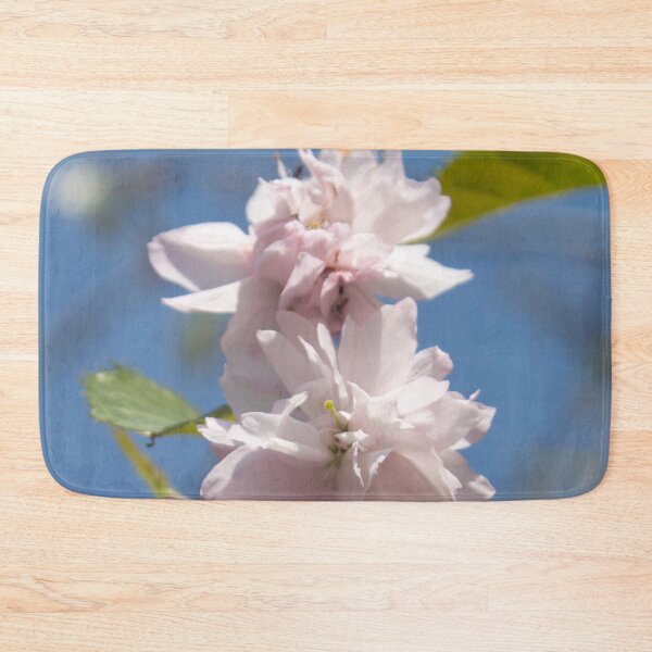 Item preview, light pink flowers on a tree branch against a blue sky background designed and sold by nataliavavilina.