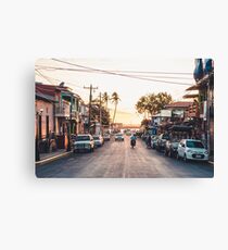 Sun sets in the village Canvas Print