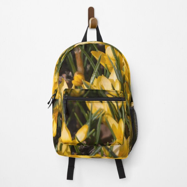 Item preview, pattern of yellow flowers crocuses and green leaves on a dark background designed and sold by nataliavavilina.
