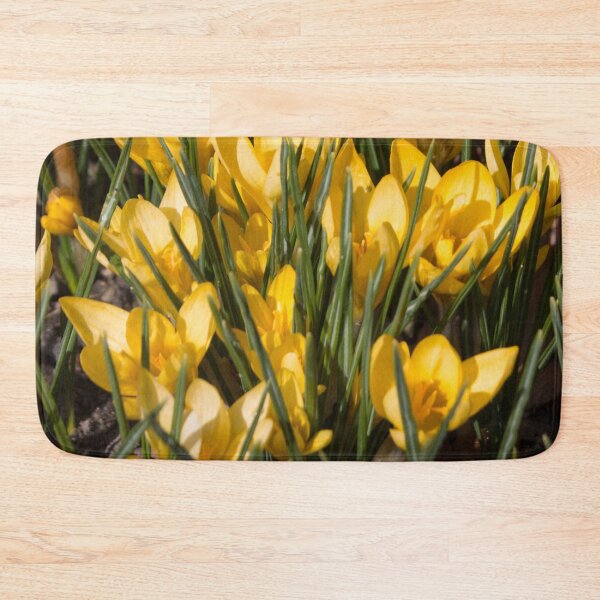 Item preview, pattern of yellow flowers crocuses and green leaves on a dark background designed and sold by nataliavavilina.