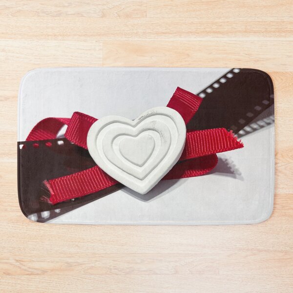 Item preview, A white heart with red ribbon resting on a photographic film designed and sold by brambillasimone.