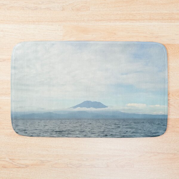 Item preview, landscape a volcanic island in the ocean and the blue sky above it designed and sold by nataliavavilina.