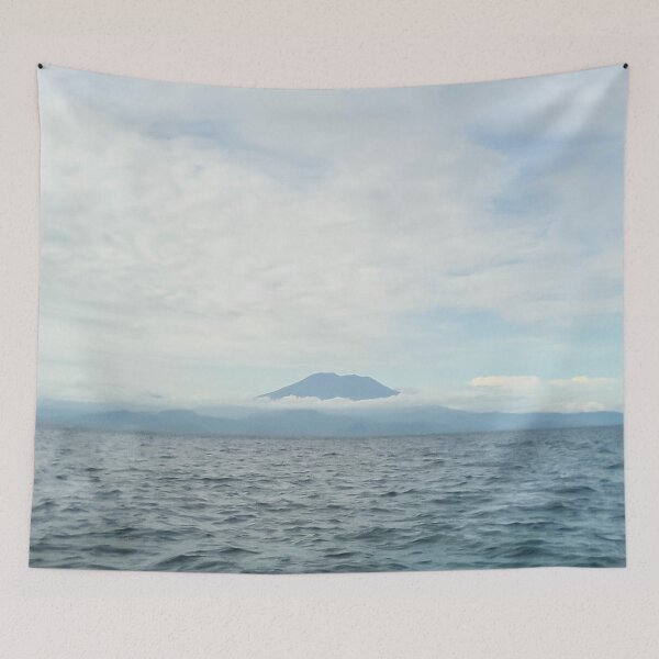 Item preview, landscape a volcanic island in the ocean and the blue sky above it designed and sold by nataliavavilina.