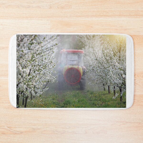 Item preview, tractor sprays insecticide in cherry orchard springtime designed and sold by goceris.