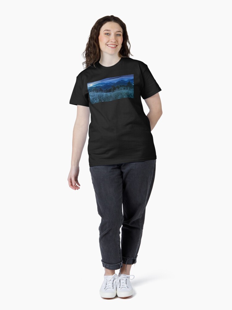 Thumbnail 4 of 7, Classic T-Shirt, panorama of a meadow in mountains at night designed and sold by mike-pellinni.