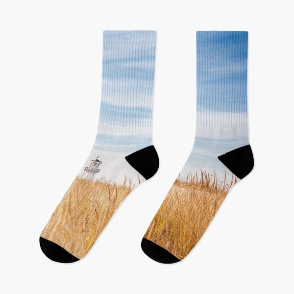 Item preview, Lighthouse visible above the dune grasses on a beach designed and sold by soupstock.