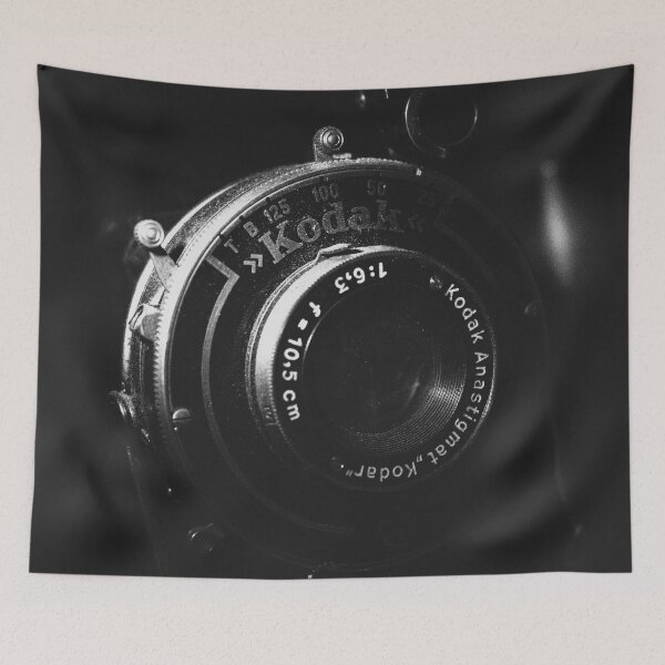Item preview, A black and white close-up photo of a vintage analog camera designed and sold by Diana van Neck.
