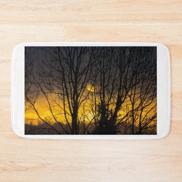 Item preview, Winter sunrise through trees in Knowbury, Shropshire designed and sold by HalcyonPrints.