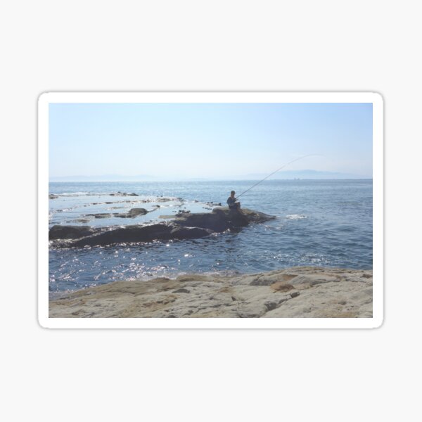 A man fishing from the shore Sticker
