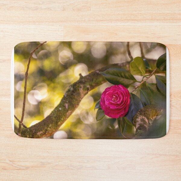 Item preview, Pink camellia flower, with branches and leaves in the background. designed and sold by AylaHarbich.