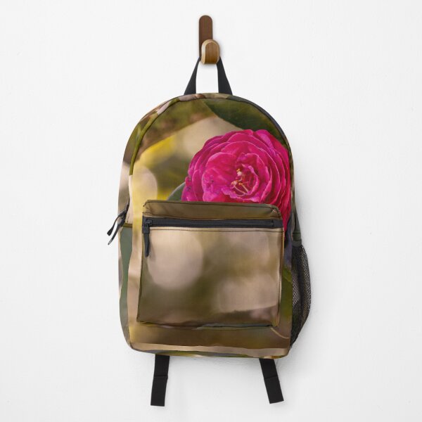 Item preview, Pink camellia flower, with branches and leaves in the background. designed and sold by AylaHarbich.