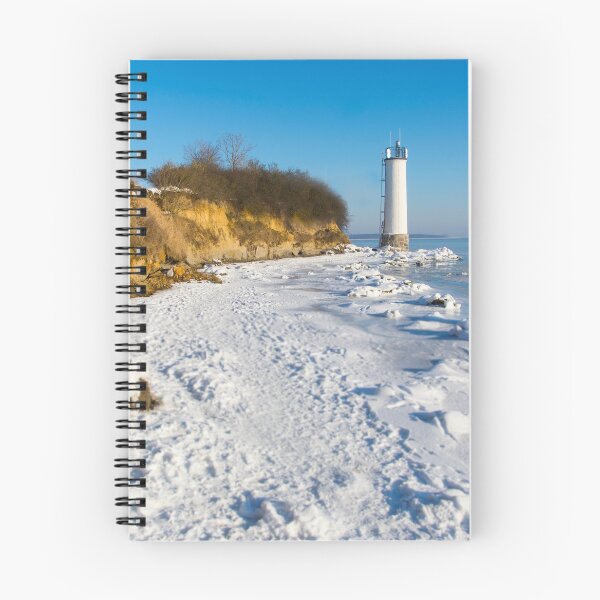 Item preview, Faro blanco en una costa nevada en la isla de Rügen, Alemania designed and sold by Michael Brewer.