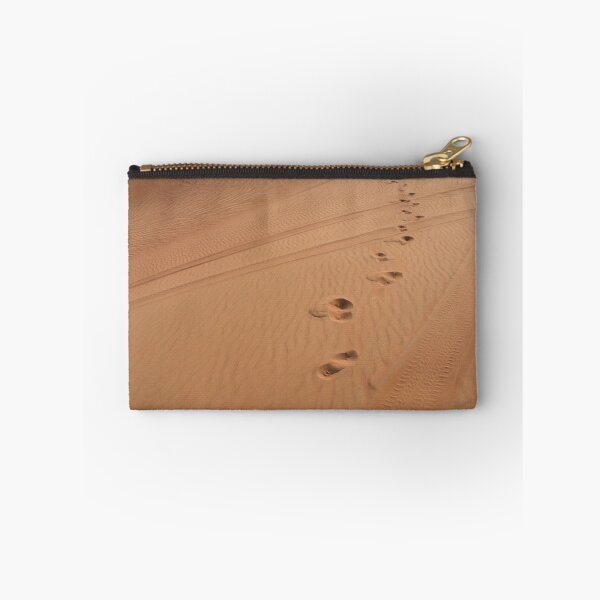 Item preview, Man walking in the desert leaving footsteps in the sand. designed and sold by oanaunciuleanu.