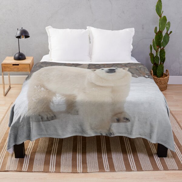 Item preview, a polar bear stands in the snow against a stone wall designed and sold by nataliavavilina.