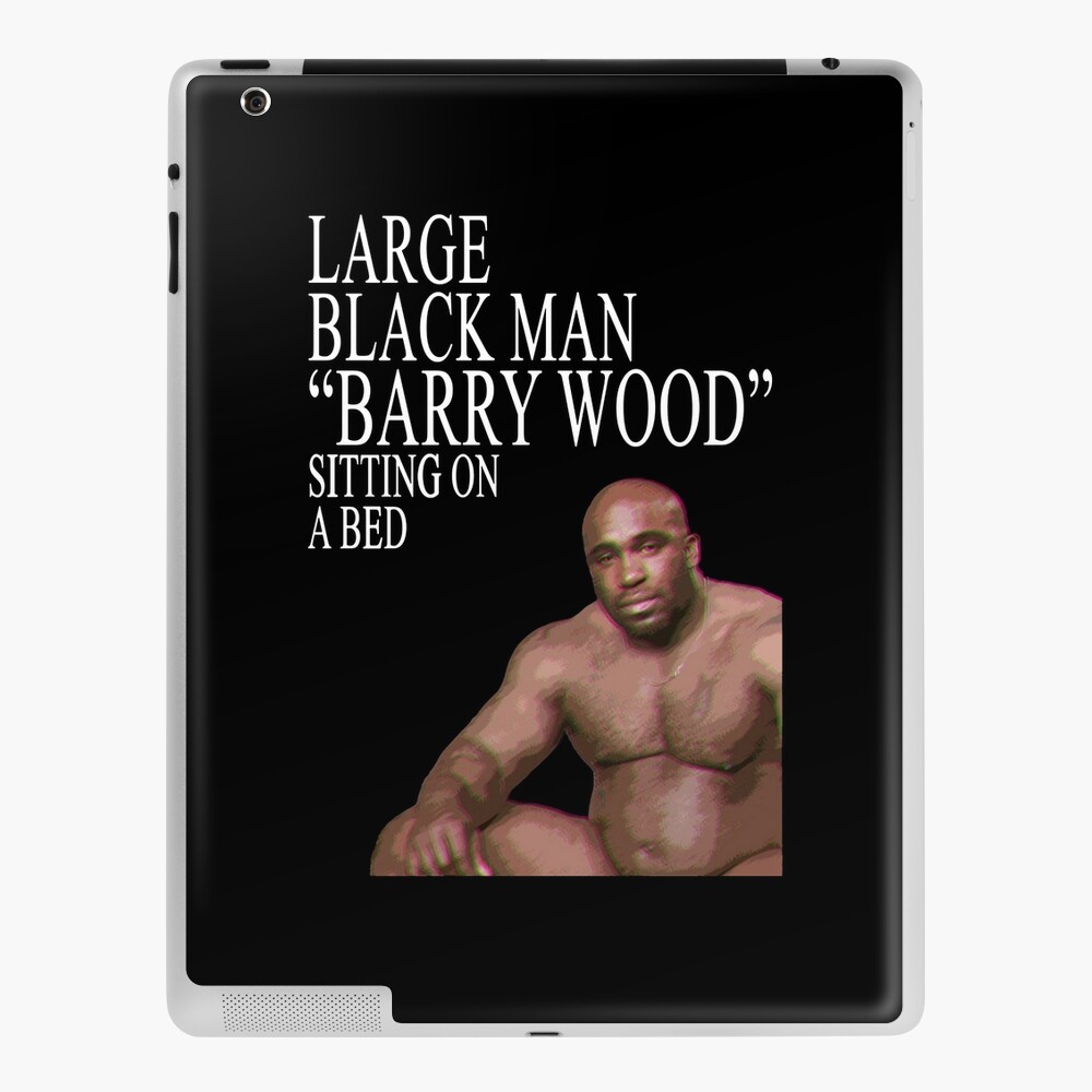 Large Black Man Barry Wood Sitting On a Bed