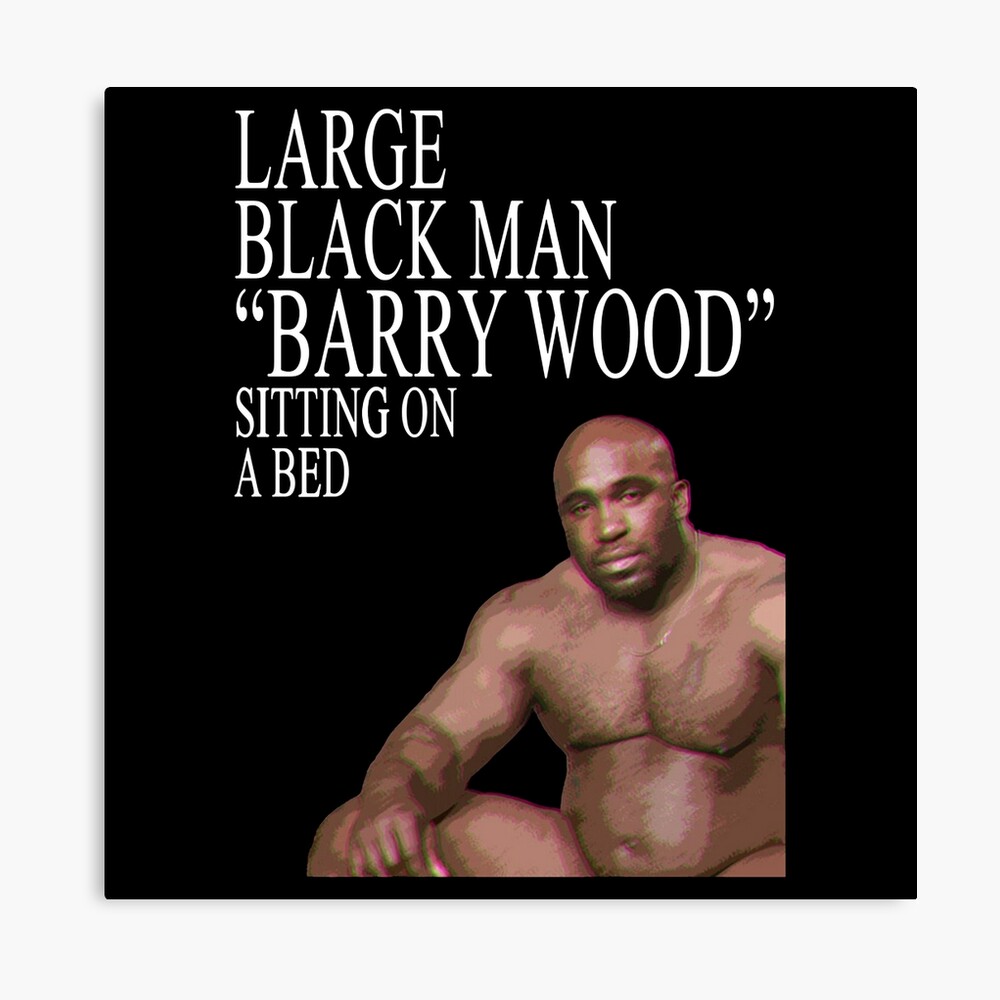 Large Black Man Barry Wood Sitting On a Bed